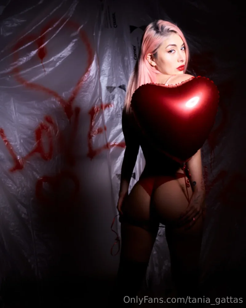 Sexy Tania Gattas in red lingerie holding a heart balloon, showing off her ass