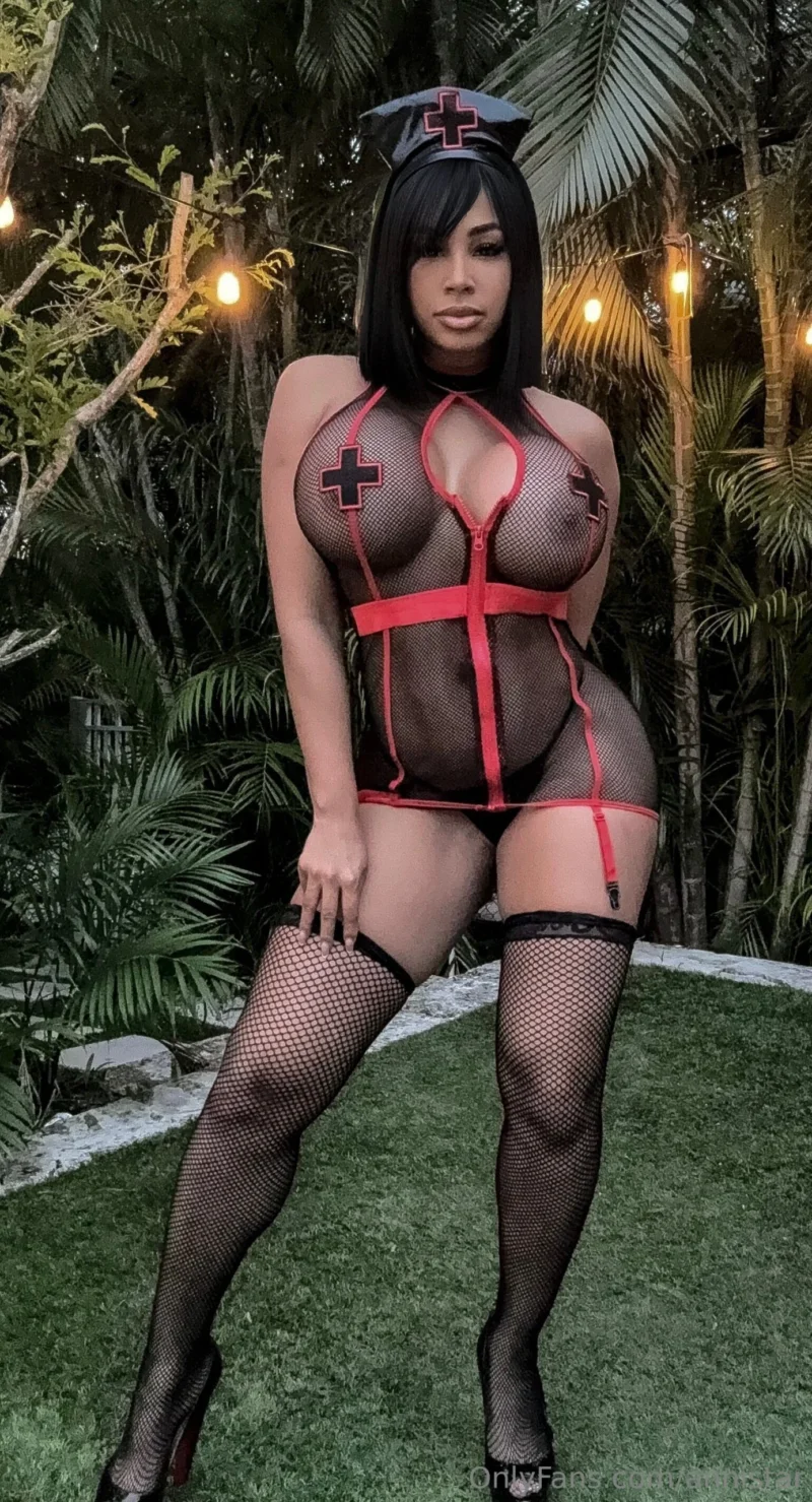 Hot Anni Star in nurse cosplay with fishnets, posing outdoors with tits out