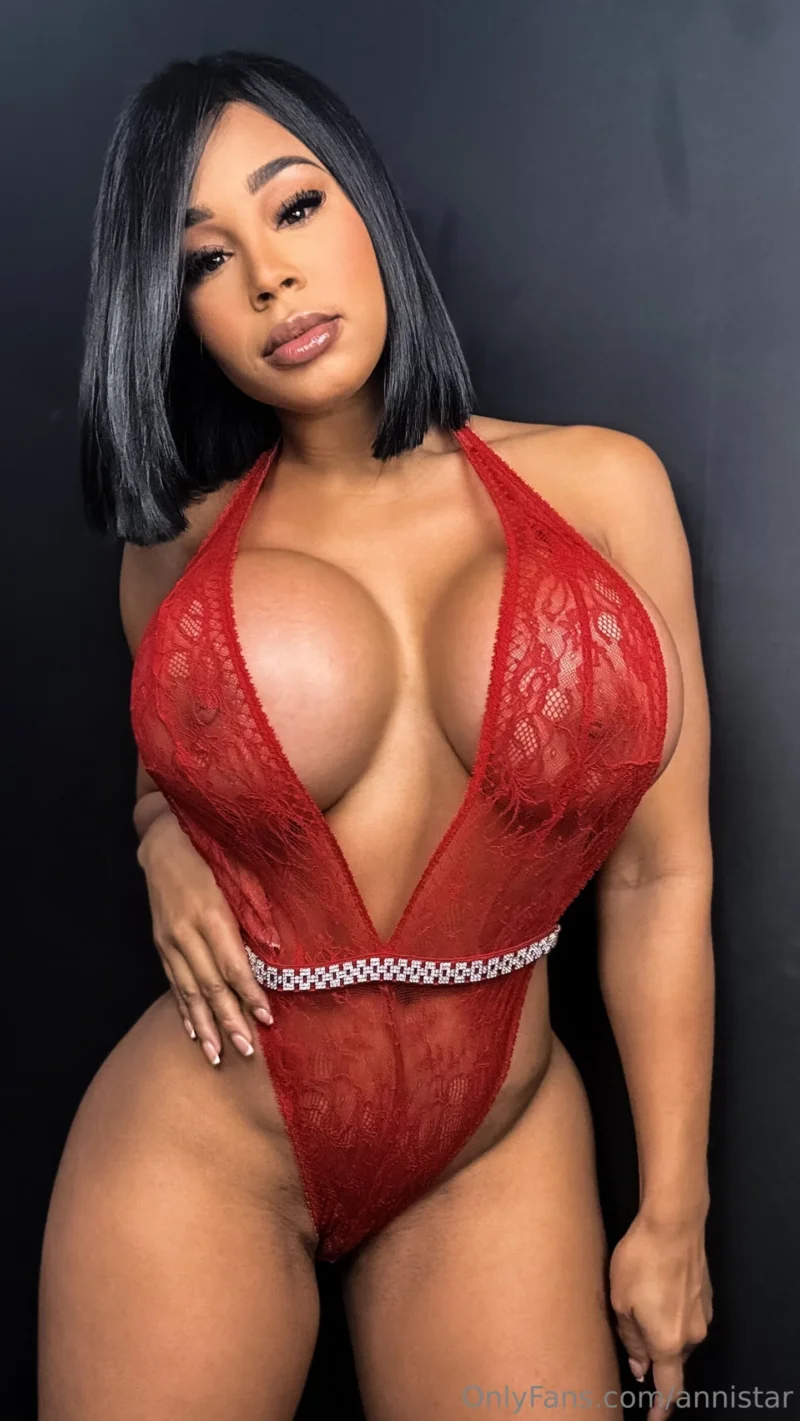 Flirty Anni Star in red lace bodysuit posing with her big tits out