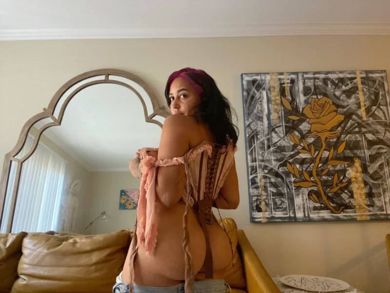 Curvy Emily Cheree turns back in lace-up top, showing off her ass in jeans