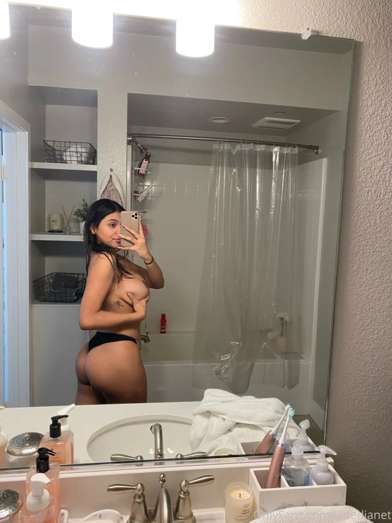 Nude lildedjanet taking a bathroom mirror selfie in black thong