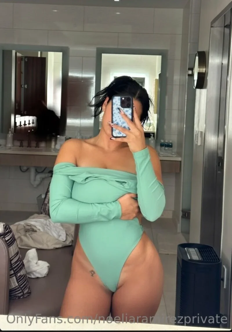 Curvy Noelia Ramirez in mint green bodysuit takes mirror selfie, one hand on hip