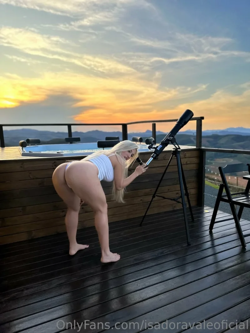 Hot Isadora Vale in white thong bends over deck railing while looking through telescope at sunset