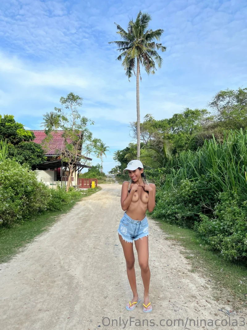 Curvy Nina cola topless on a dirt road in denim shorts and flip flops