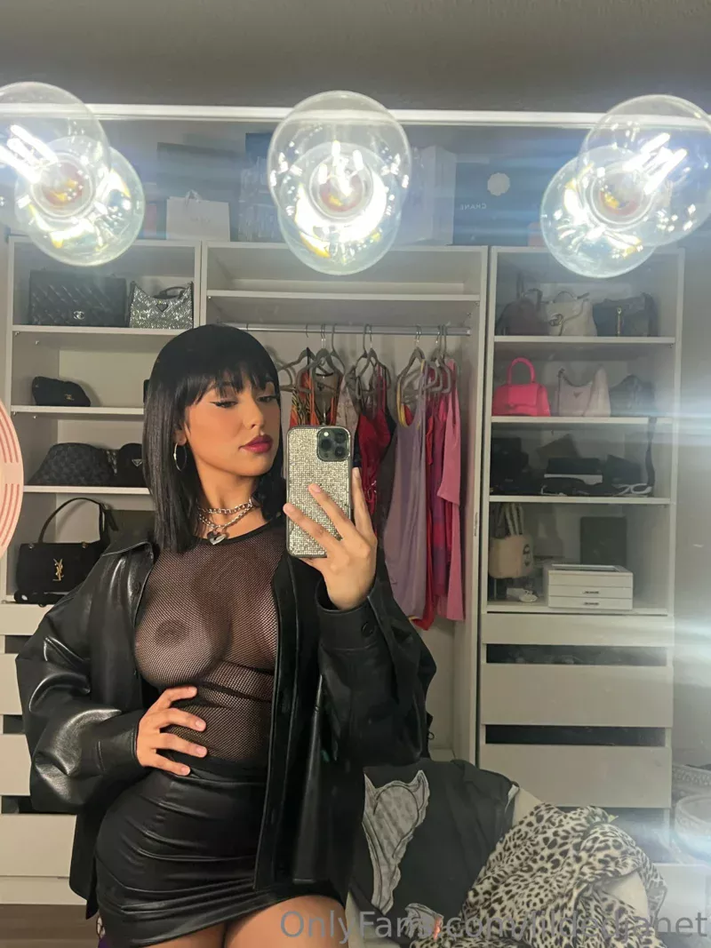 Seductive lildedjanet in black mesh top and leather jacket takes mirror selfie in closet