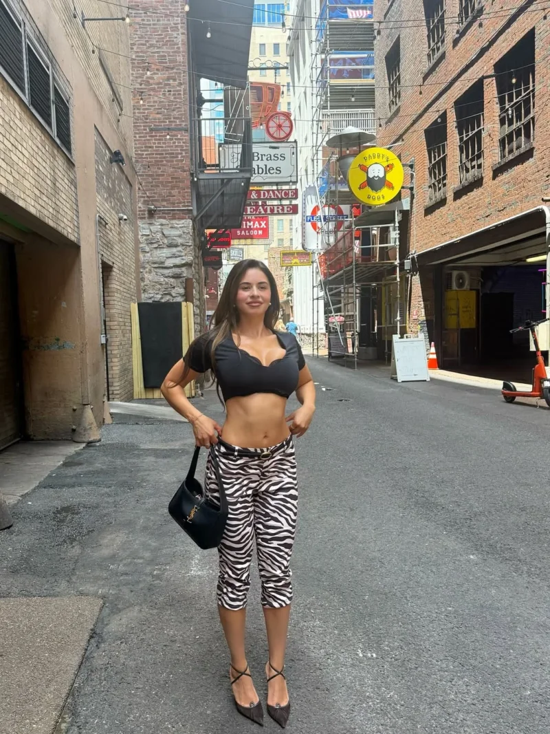 Hot Noelia Ramirez posing in zebra pants and black crop top on a city street