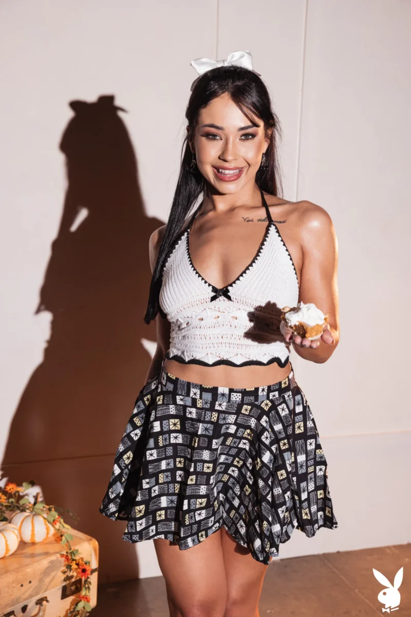 Seductive Bec The Barbie in crocheted top and patterned skirt holding a cupcake